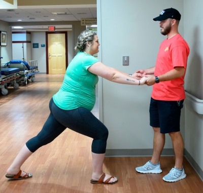 soon to be mother lunging and husband helping her